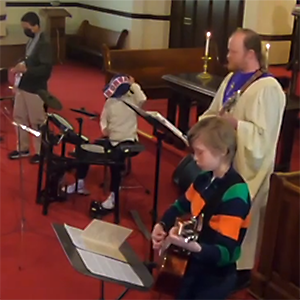 Photo of a student band performing at a church for service.