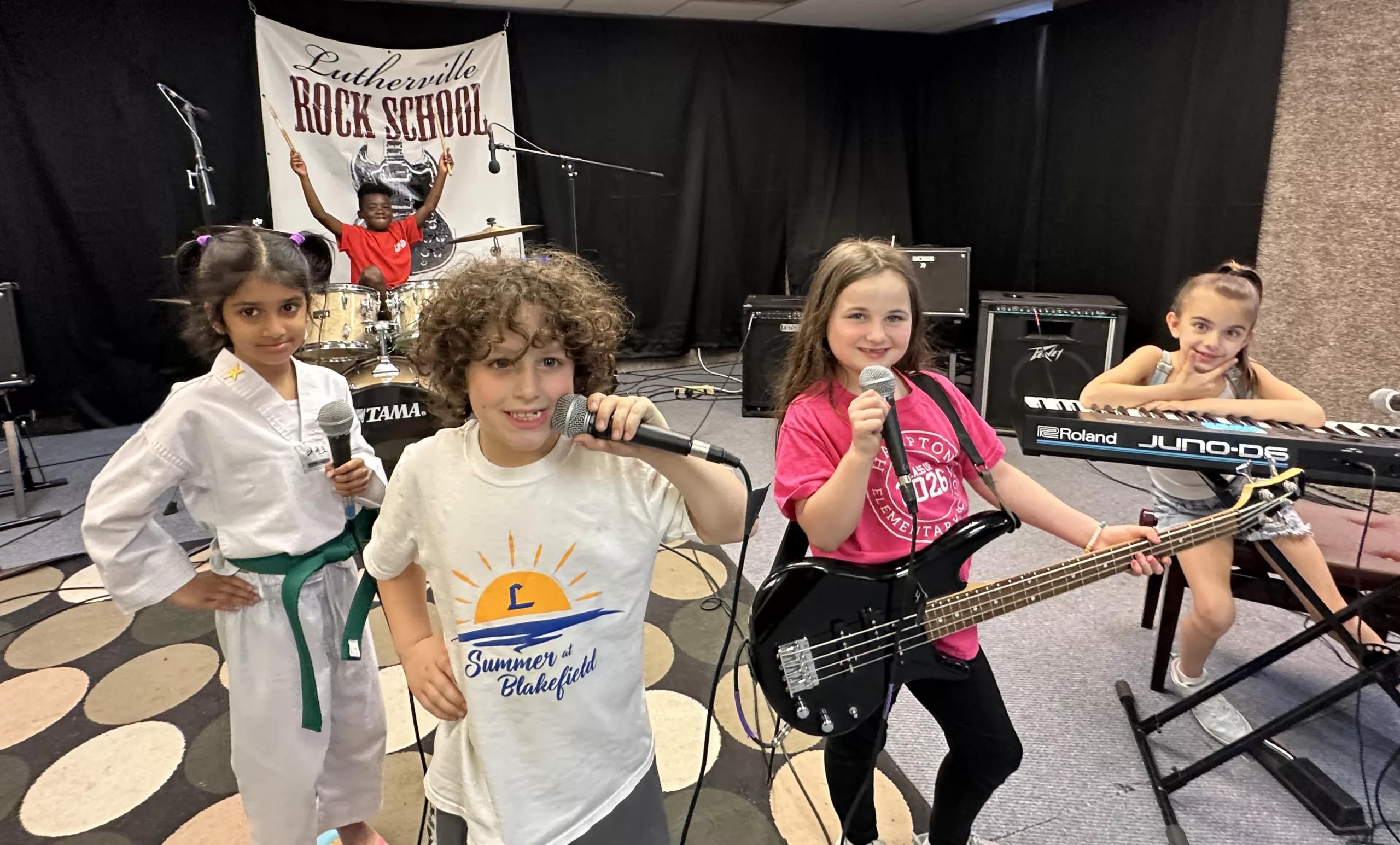 Photo of child students posing with their instruments in a band.