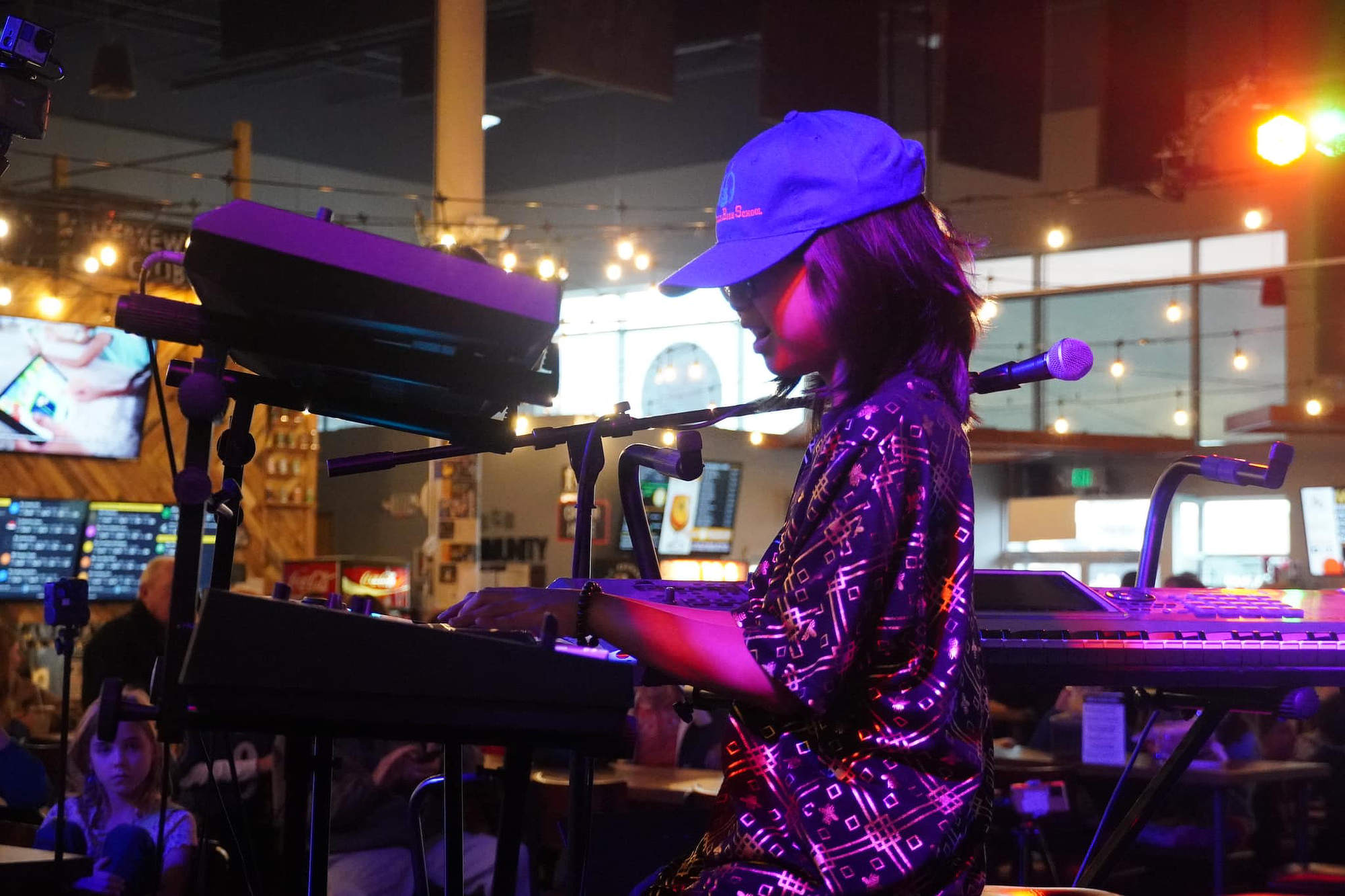 A student playing keyboard on stage.