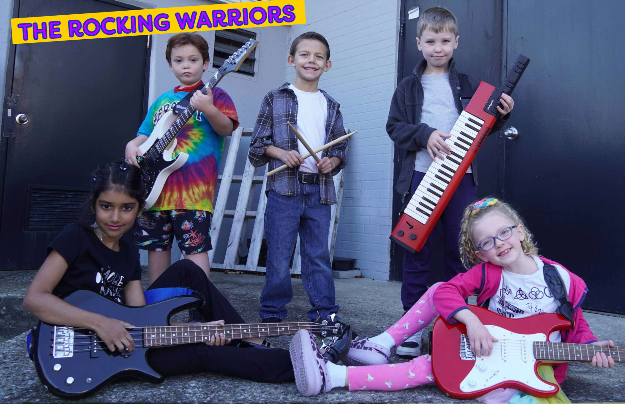 A student band posing with their instruments with the words "The Rocking Warriors" across the top.