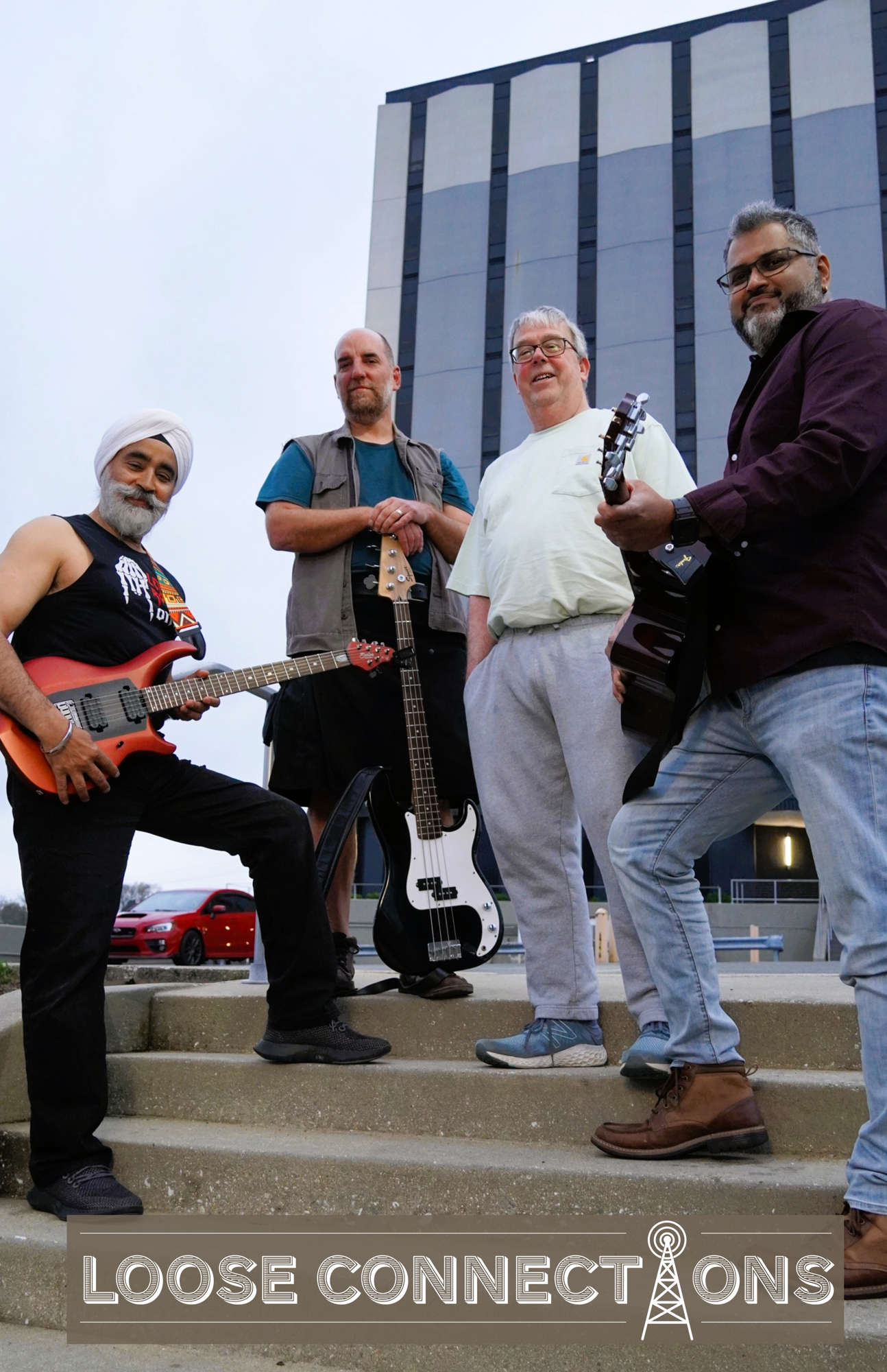 An adult group of musicians posing with their instruments on a staircase with the words "Loose Connections" written below them.