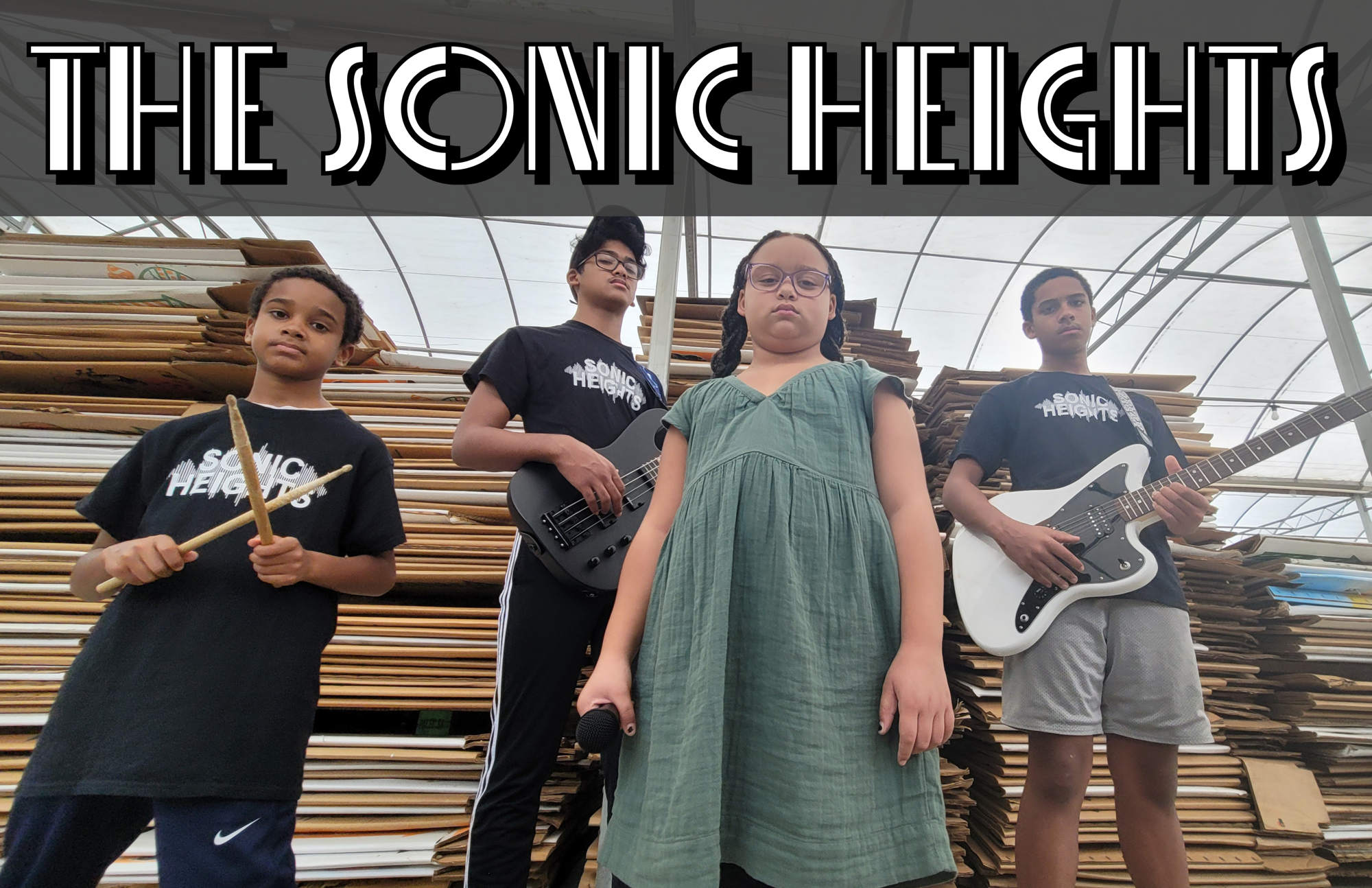 A student band posing with their instruments with the words "The Sonic Heights" across the top.