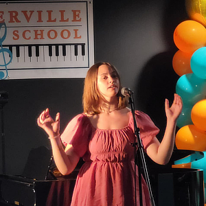 A student singing on stage.