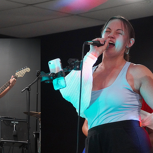 A woman singing on stage.