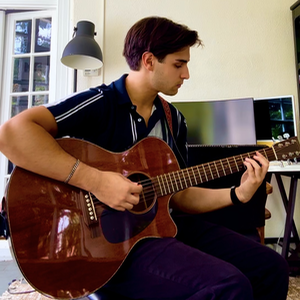 A photo of Liam Arnold playing guitar.