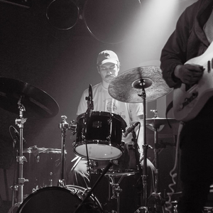 A picture of Skye Paddock playing drums on stage.