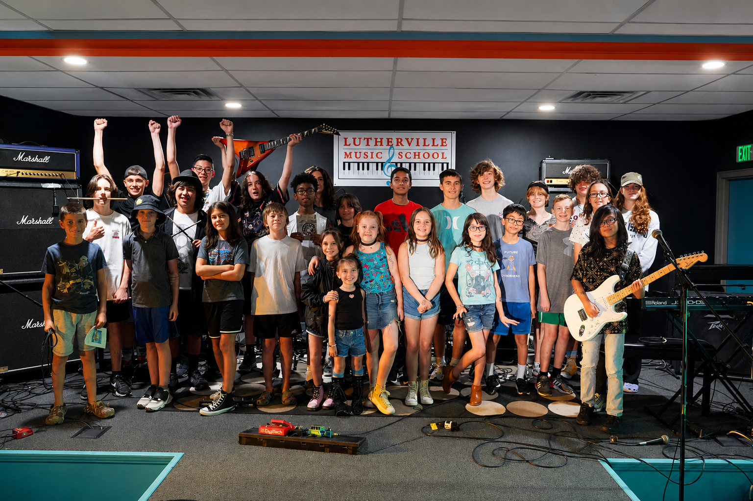 Students celebrating after a summer music camp band performance at Lutherville Music School